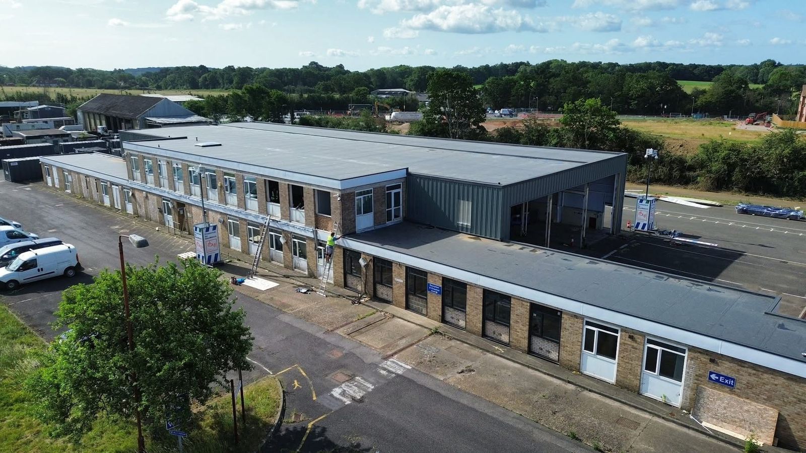 Aerial view of a commercial office and warehouse block with newly completed flat roofs